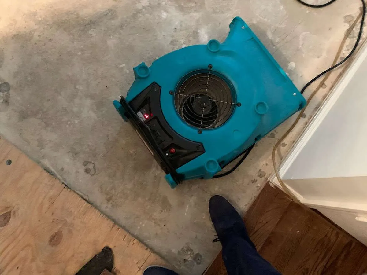 Air mover drying subfloor during Commercial Water Damage Restoration in Bonita Springs